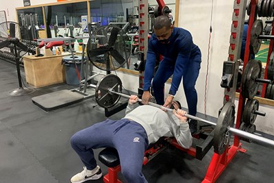 UMass Lowell exercise science student Michael Hines works with an athlete at Athletic Evolution
