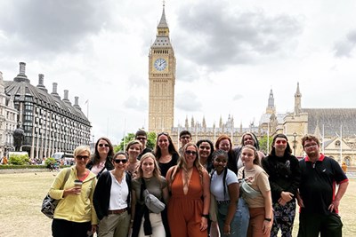 A group of students pose with their professor in front of Big Ben in London