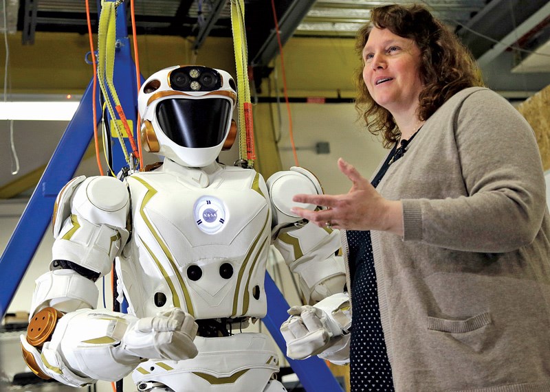 UMass Lowell Prof. Holly Yanco stands with robot, Valkyrie