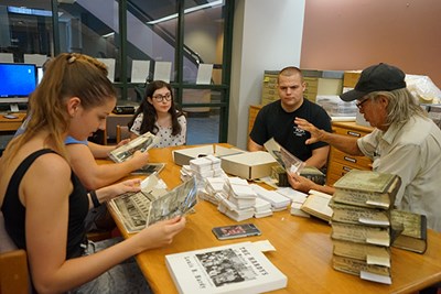 Students in the First-year Seminar in Honors at UMass Lowell do research at the Center for Lowell History, with local historian Bill Walsh