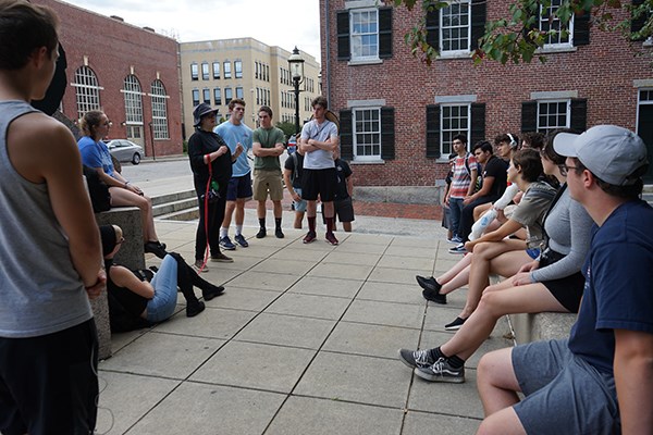 Visiting Honors College Prof. Rachel Mansfield talks to her First-year Seminar in Honors students outside the Boarding House Museum at Lowell National Historic Park.