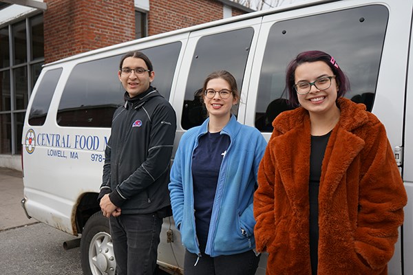UML Honors College students Joseph Calles, left, and Morgan Engdahl, right, with Gretchen Gallimore, executive director of Central Food Ministries