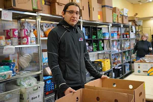 UML Honors computer science major Joseph Calles has volunteered at Central Food Ministry for more than a year