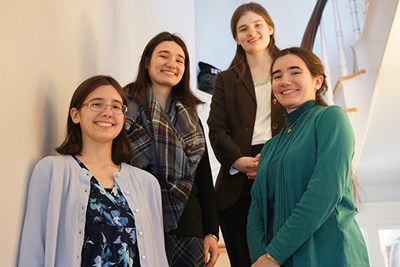 From left: sisters Margaret, Eleanora, Rose and Regina Peters on a stairway in UMass Lowell's Allen House, home of the Honors College