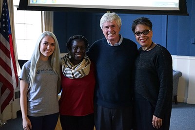 Olga Tines and two students pose with All Hands co-founder David Campbell at Alumni Hall