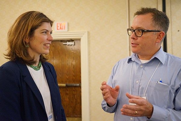 GAO analyst-in-charge Nora Boretti talks with conference participant Bill Roche  at Voices of Hunger 2019