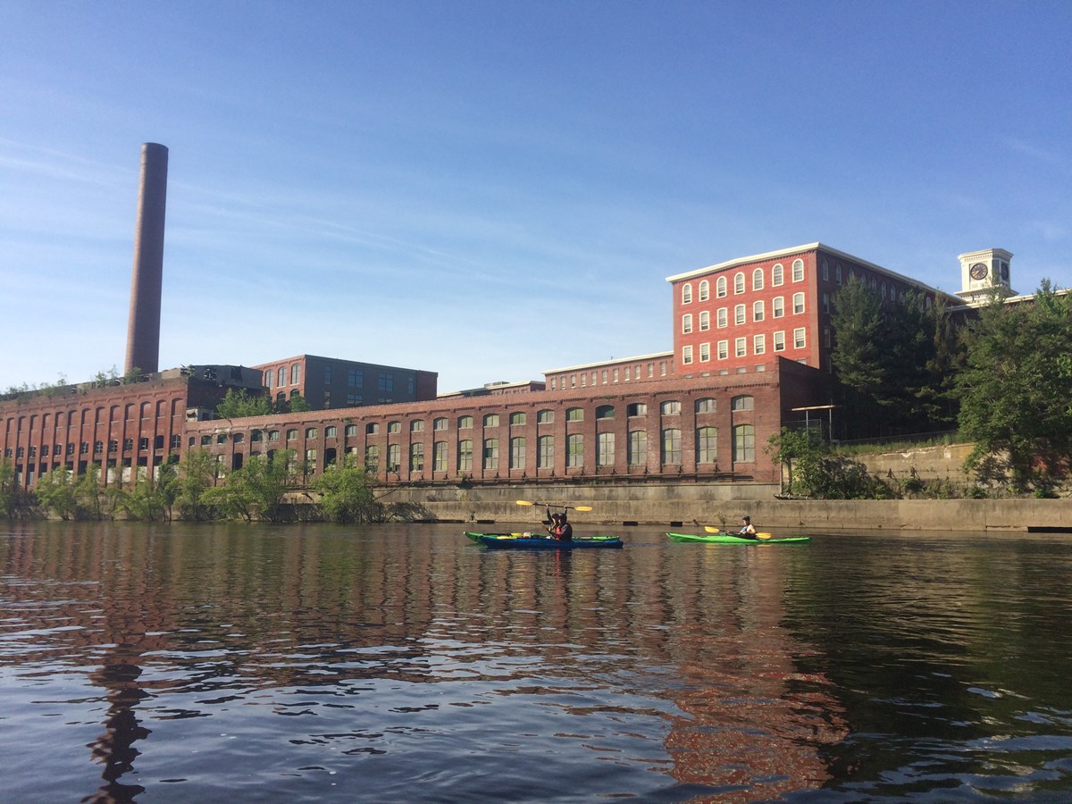 Kayaker Passing by Mills in Downtown Lowell