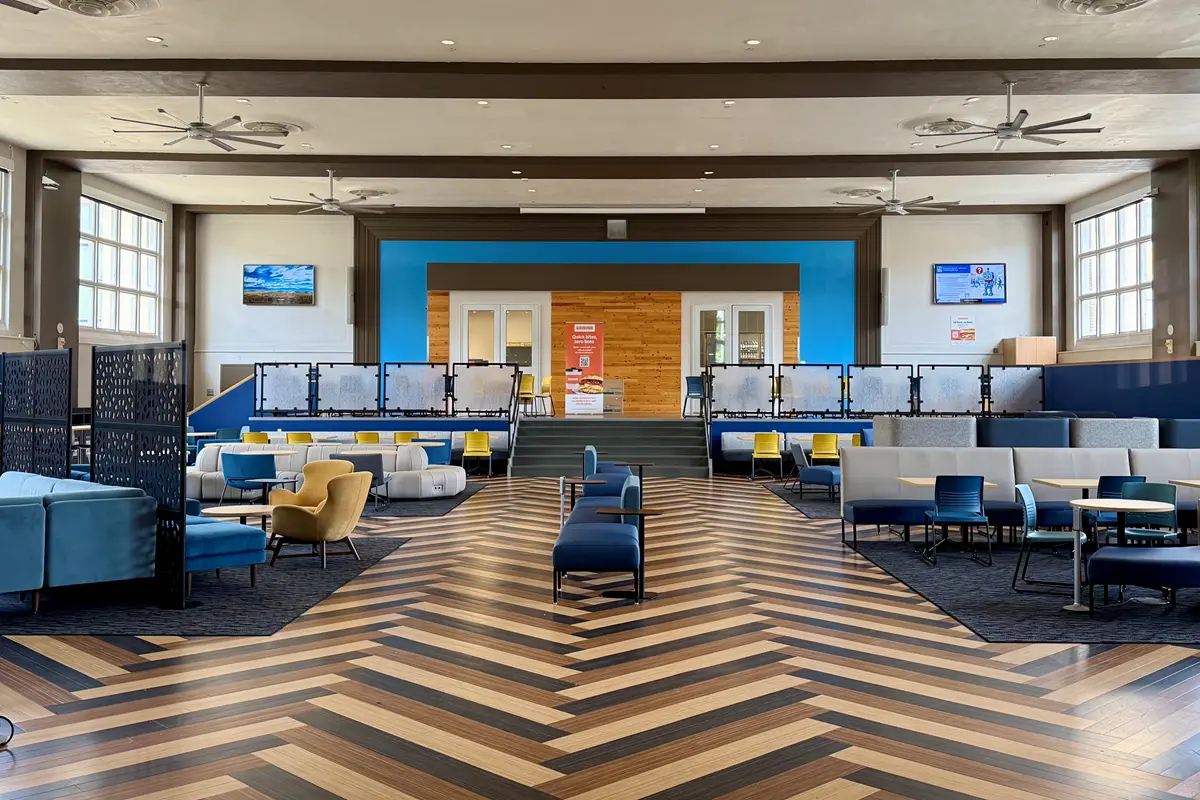 A large room with furniture where college students can gather and eat.