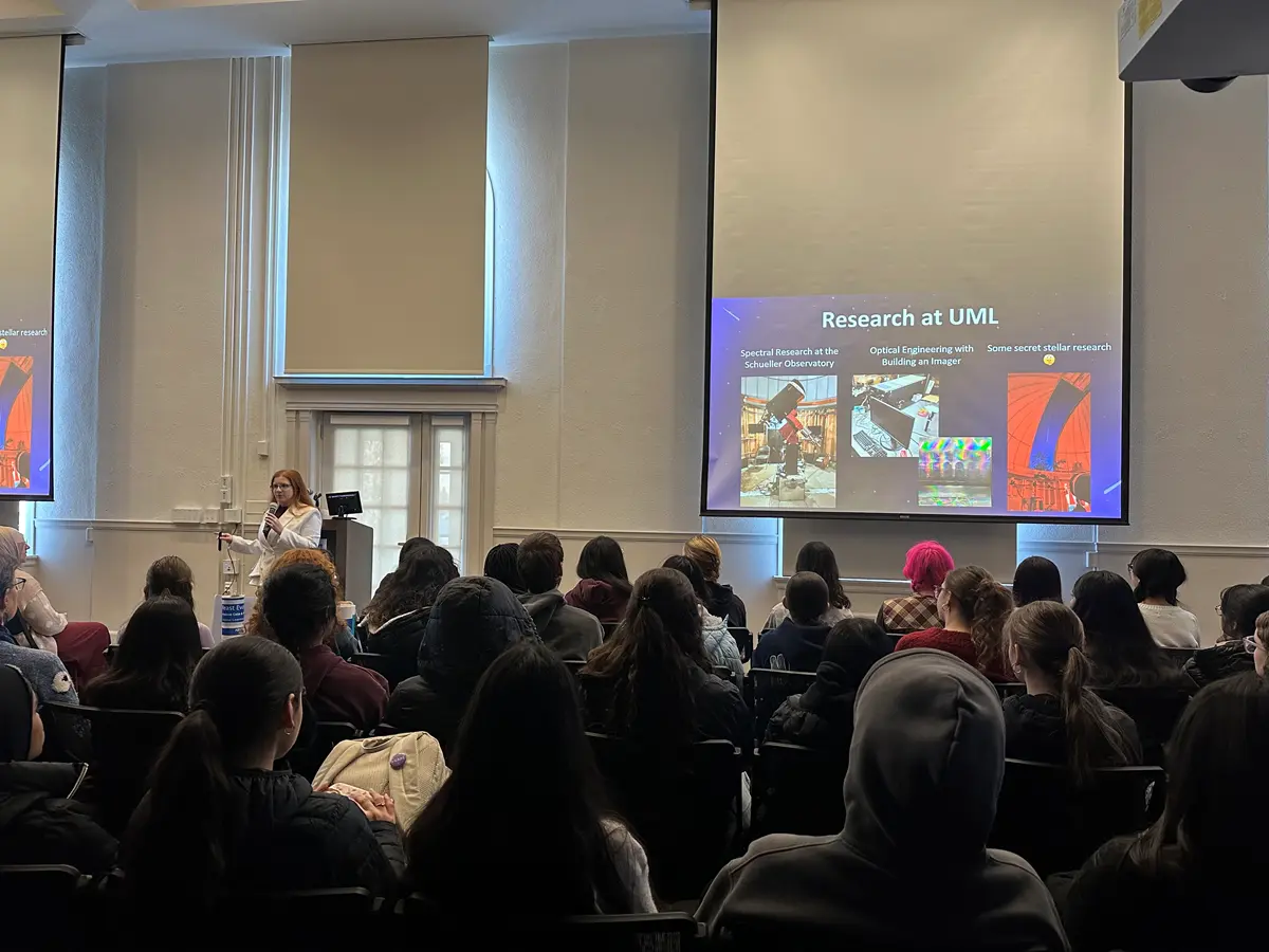 Undergraduate student, Julie Sage, presenting “Research at UML” to visitors.