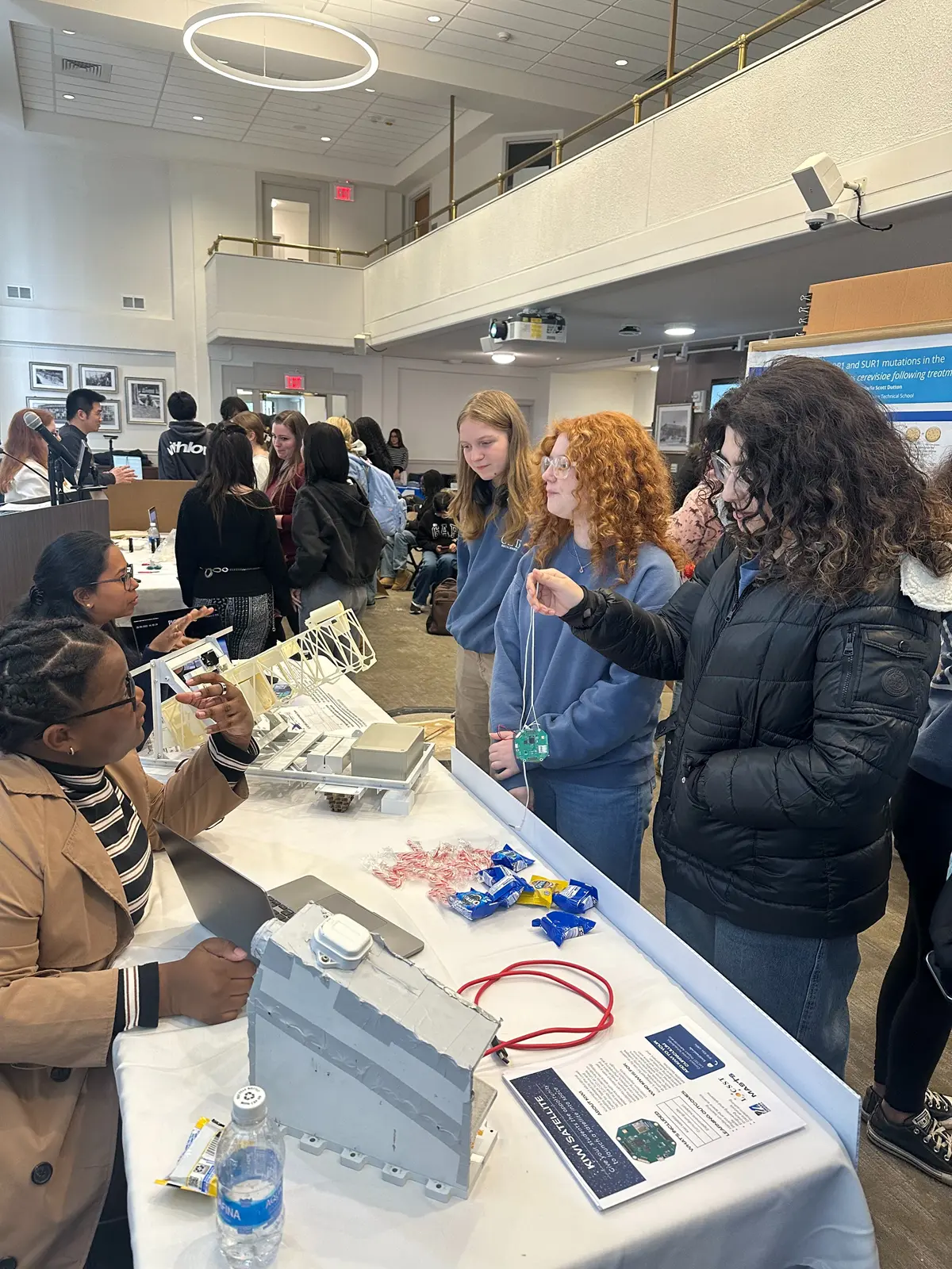UMass Lowell's Destinee Jeanty and Ananya Sahoo show visiting students research demonstrations.