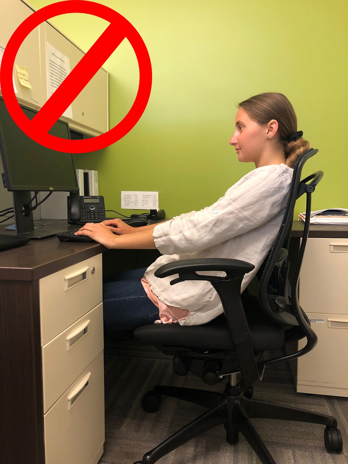 A no sign over a picture of a woman slouching in her chair so that her back is not supported by the backrest.