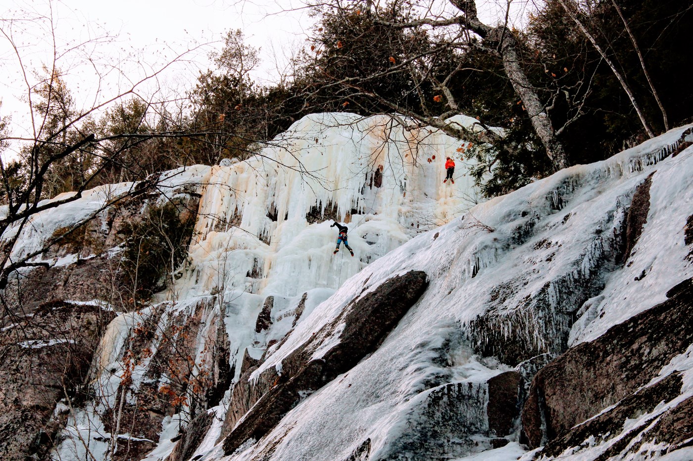 Two Ice Climbers High on a Cliff