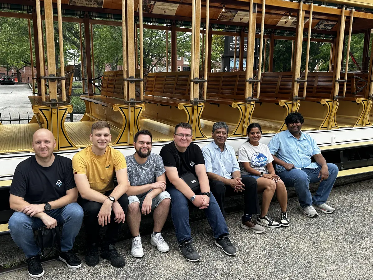 seven people sitting down next to a trolley at UML LoCSST