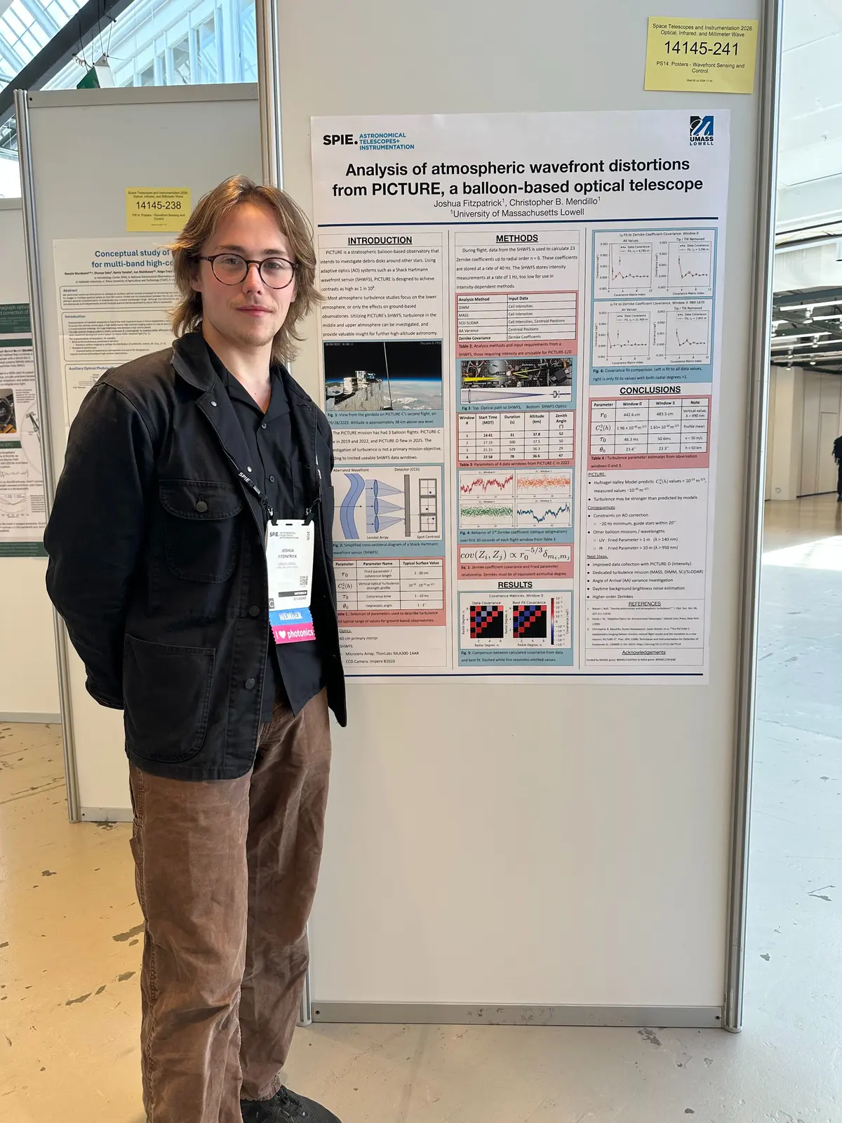 Joshua standing next to his research poster at SPIE conference in Denmark. 