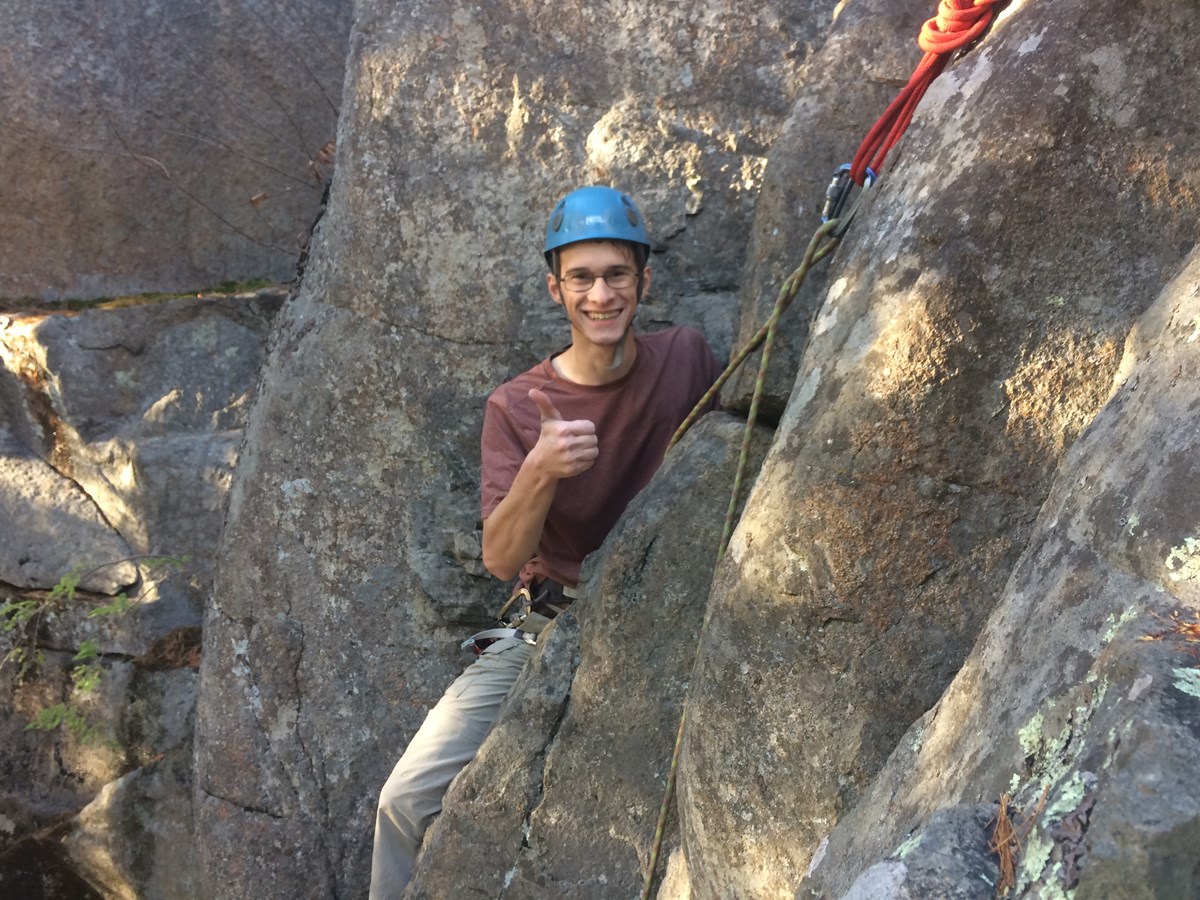 Rock climber with a big thumbs up