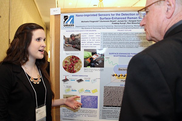 Student presenting her poster at the symposium