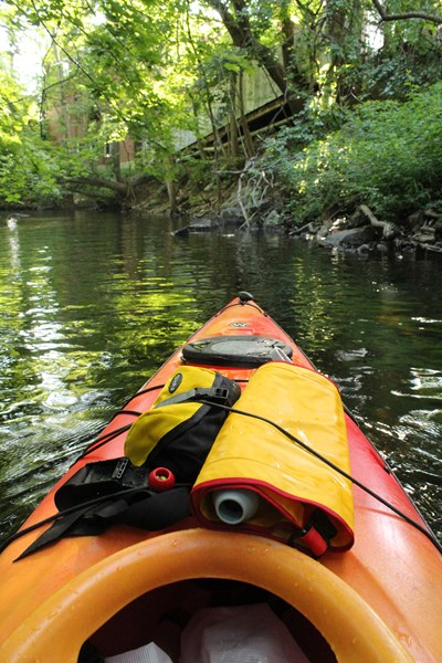 View from inside kayak while paddling up the river.