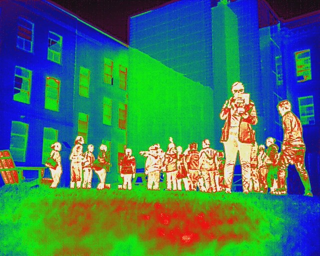 A group of students are pictured in front of Dandeneau Hall using infrared imagery captured by drone