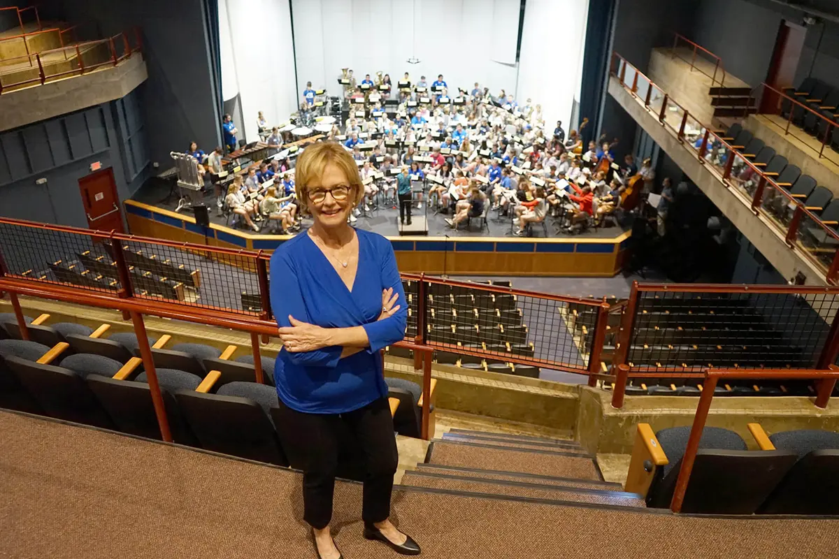 Jacqueline Moloney with the 2025 cohort of Moloney Scholars at UMass Lowell in auditorium.