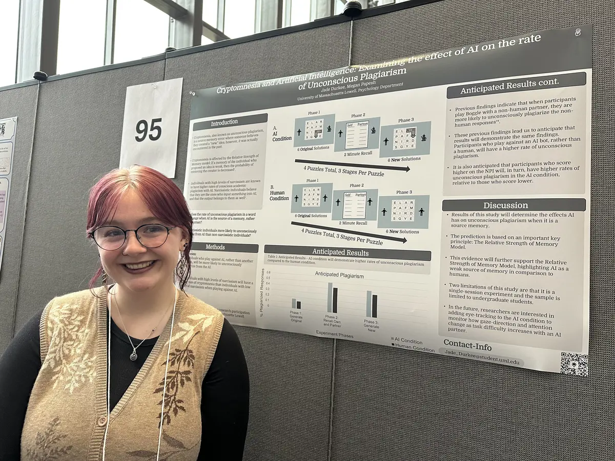 Jade Durkee in front of her poster