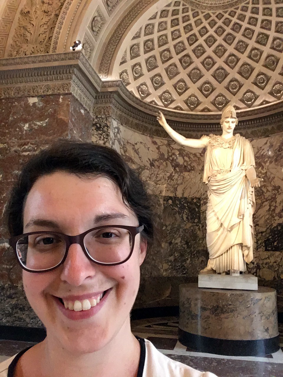 UMass Lowell Assistant Professor of History Jane Sancinito  poses for a picture in front of  the statue of Athena at the Louvre museum.