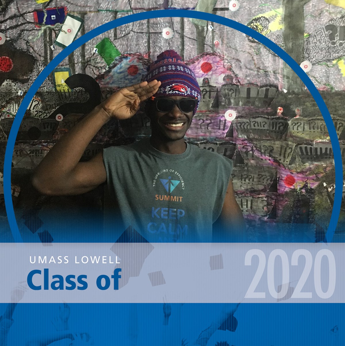 Headshot of Jean-Luc Alexandre in front of a painted canvas with a blue decorative frame around it that reads "UMass Lowell Class of 2020."