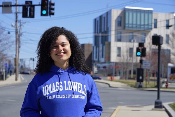 Graduate student Jenna Howard stands in front of University Crossing on Pawtucket Street