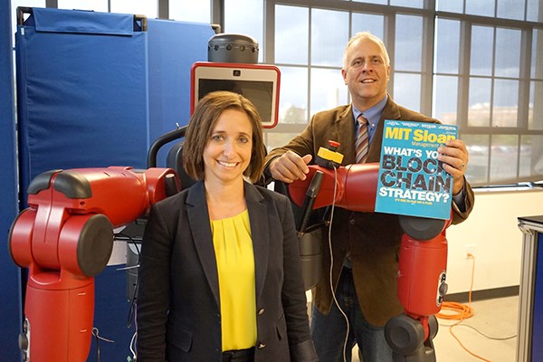 Beth Humberd and Scott Latham pose with a robot at the NERVE Center