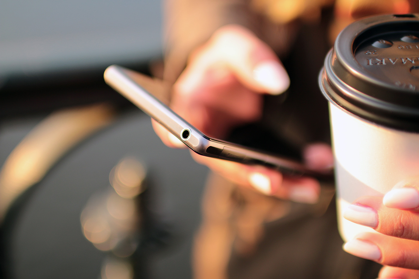 Hand holding phone and coffee. CONTACT US Join our mailing list, send us a question or feedback.