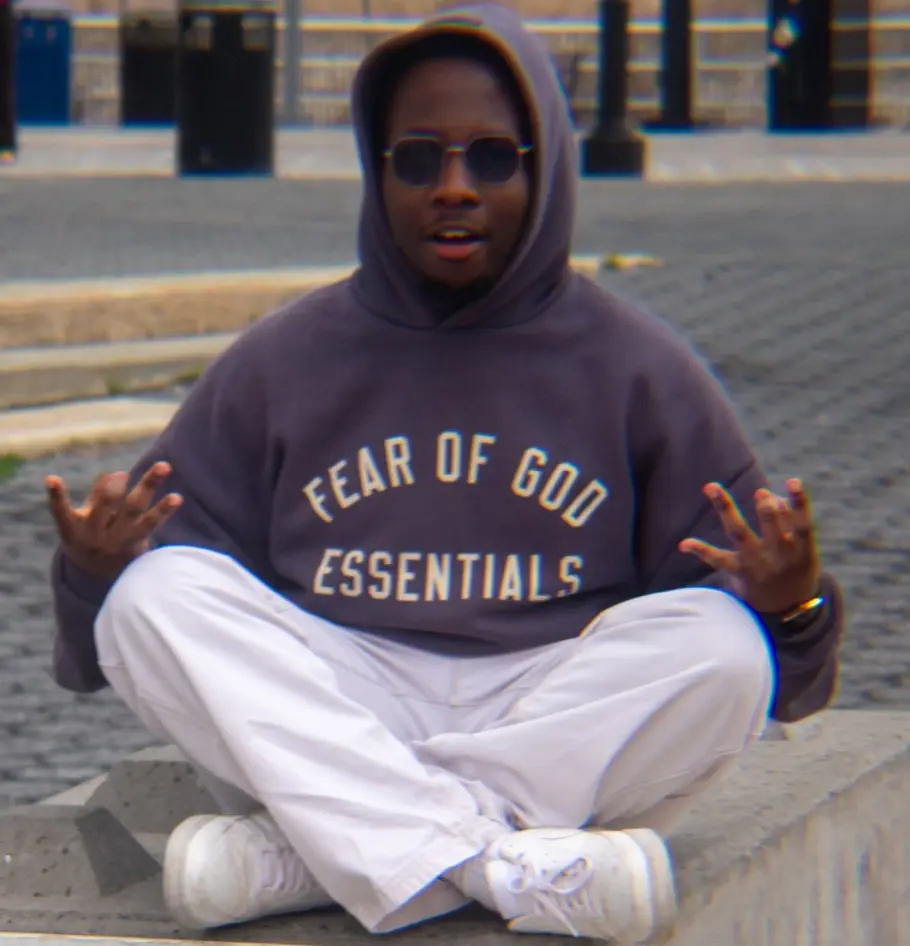 Joel Nsubuga wearing Fear of God Eddentials hoodie.