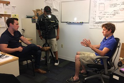UML Asst. Prof. John Cluverius is interviewed by a TV reporter before the 2018 midterm elections