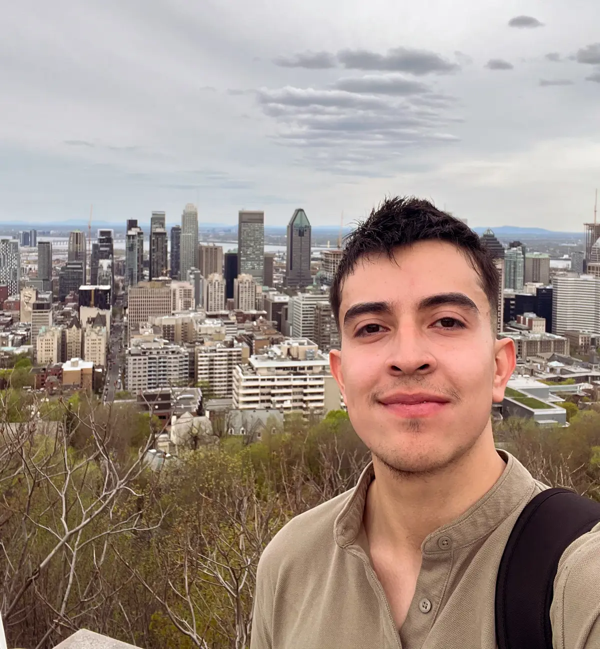 Julian Viviescas Mejia with a cityscape behind them.