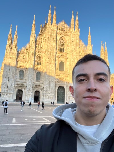 Julian-Viviescas stands in front of a cathedral church in Modena, Italy.