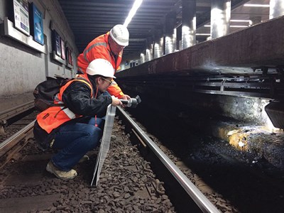 Julie Eaton Ernst inspects an MBTA tunnel with co-worker