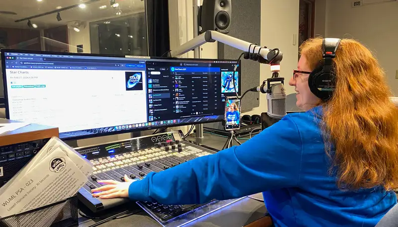 Julie Sage works with radio equipment at WUML, the UMass Lowell radio station.