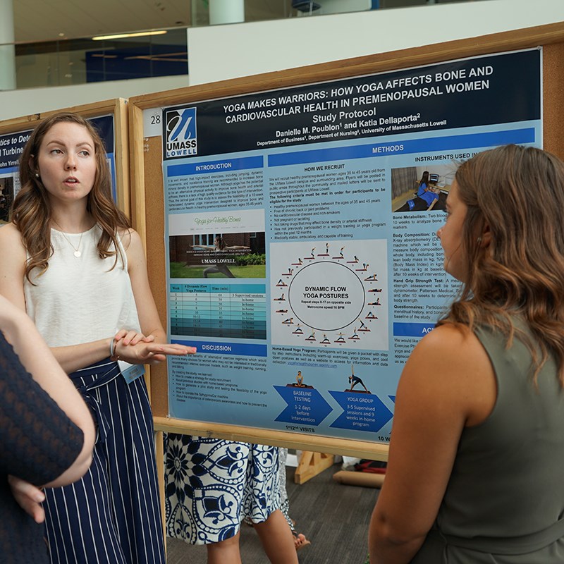 Katia and Danielle presenting their poster at a research symposium