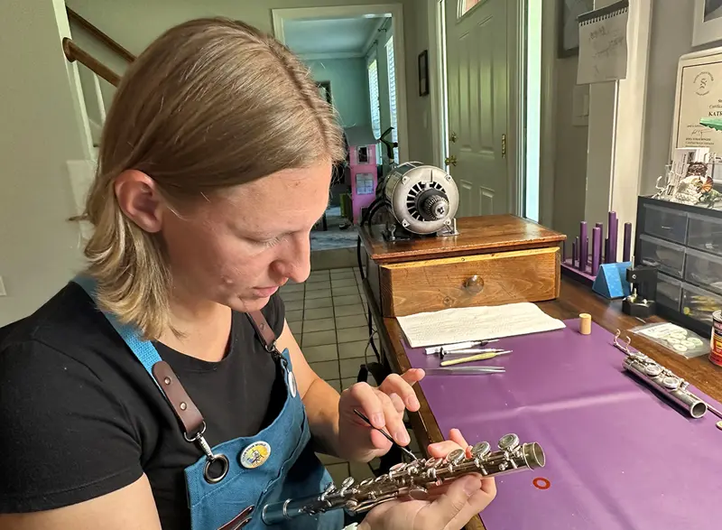 Katrina Cruess working on a flute.