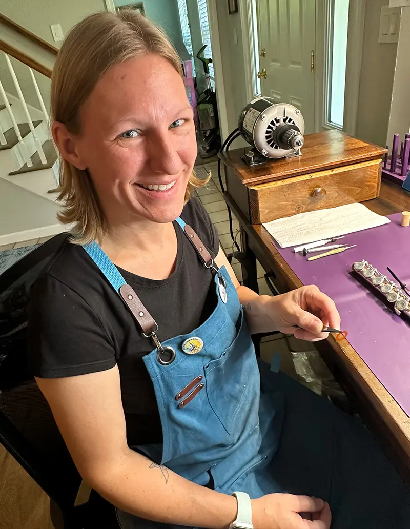 Katrina Cruess working on a flute.