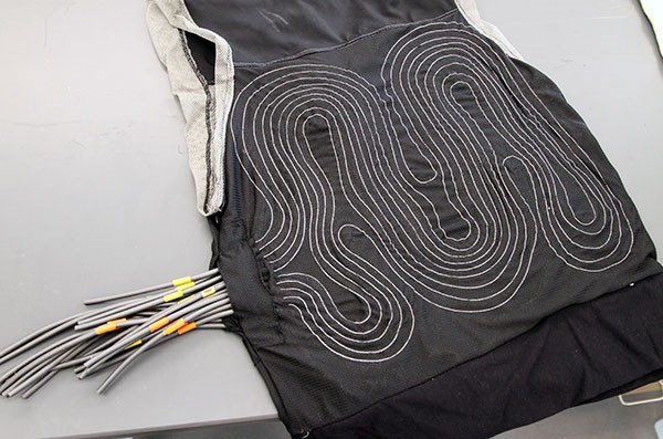 Wires enmeshed in a black vest intended to keep a person cool.