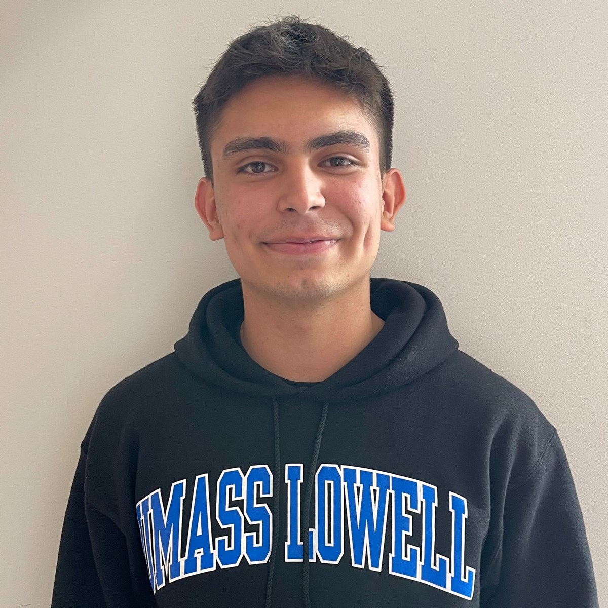 Kenneth Ibarra Suarez, wearing a black hoodie with the words UMASS LOWELL on it.