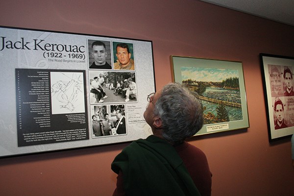 A visitor reads a poster in the Kerouac Room