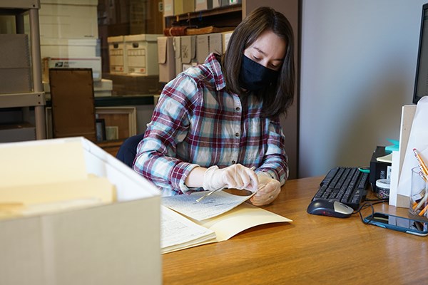 UMass Lowell history major Brianne Puls working in the John Sampas Collection at the Center for Lowell History