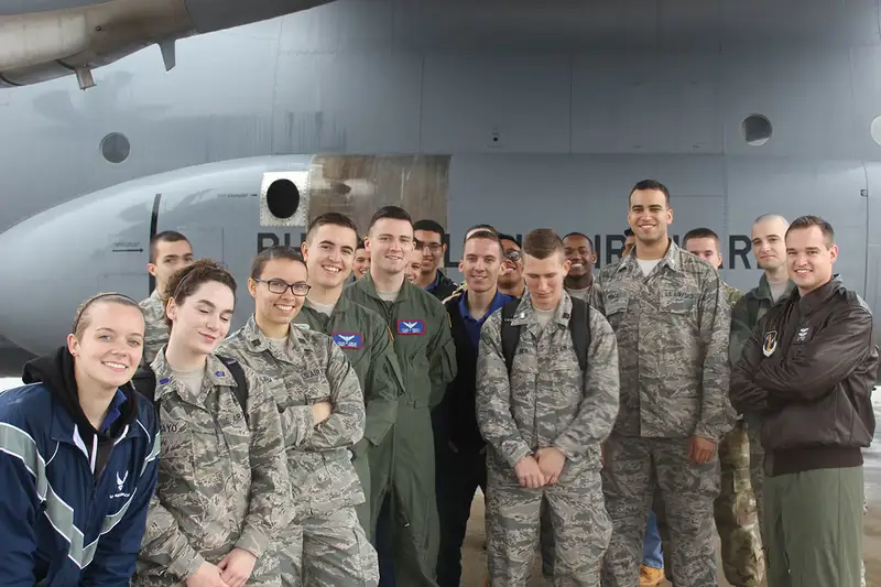 Cadets stand in front of a military plane in 2017.