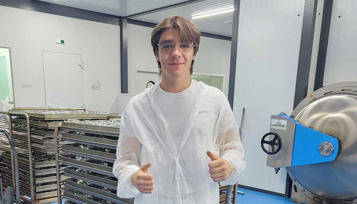 Levon Markosyan poses inside a lab while interning at a pharmaceutical manufacturing company in Armenia.