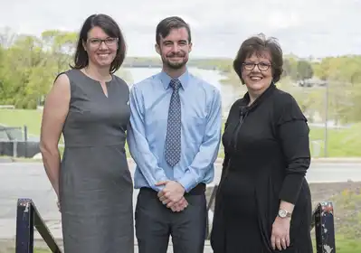 Liam Fouhy poses outside with professor Sabrina Noel Feldeisen (left), and Lawrence Senior Center Executive Director Martha Velez (right). Image used courtesy the Eagle Tribune and Amanda Sabga.