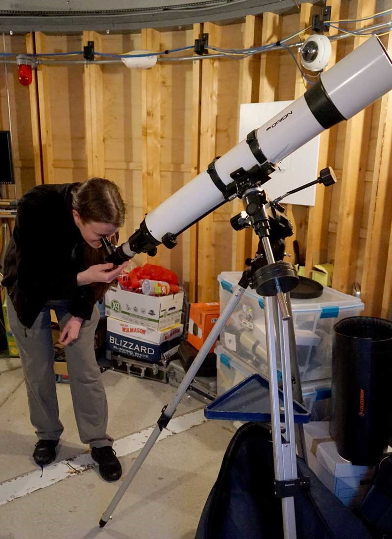 Liam Neely looks through a telescope