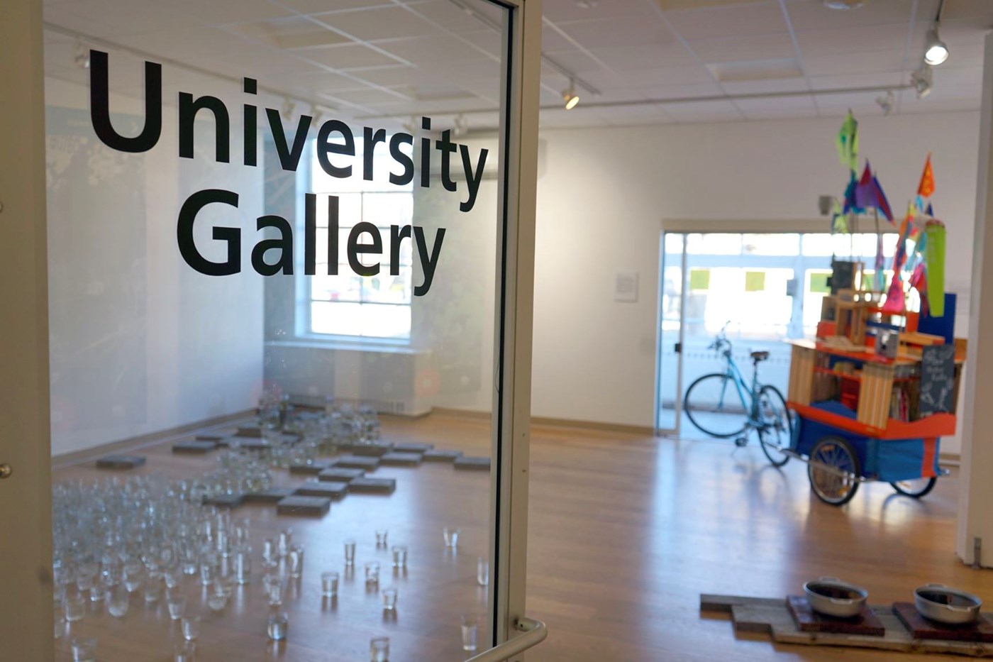 University Gallery door with exhibits inside