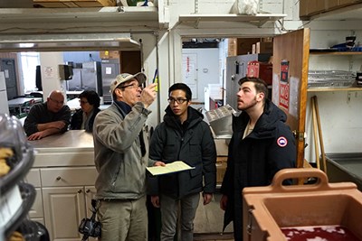 Orhan Kallogjeri and Tu Anh Huynh listen to Barry Moyer during the energy audit