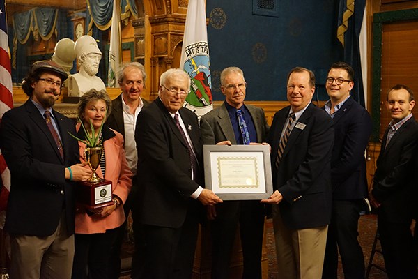 Tom Dreyer accepts a Lowell Sustainability Award from Mayor William Samaras