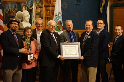 Tom Dreyer accepts a Lowell Sustainability Award from Mayor William Samaras